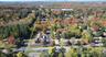 Aerial overview of property's location with a heavily wooded area and property parcel outlined