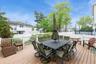Wooden terrace with outdoor dining space and fence