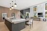 Kitchen featuring open floor plan, pendant lighting, modern cabinets, light wood-type flooring, and recessed lighting