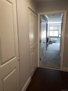 Corridor featuring baseboards and dark wood-style flooring