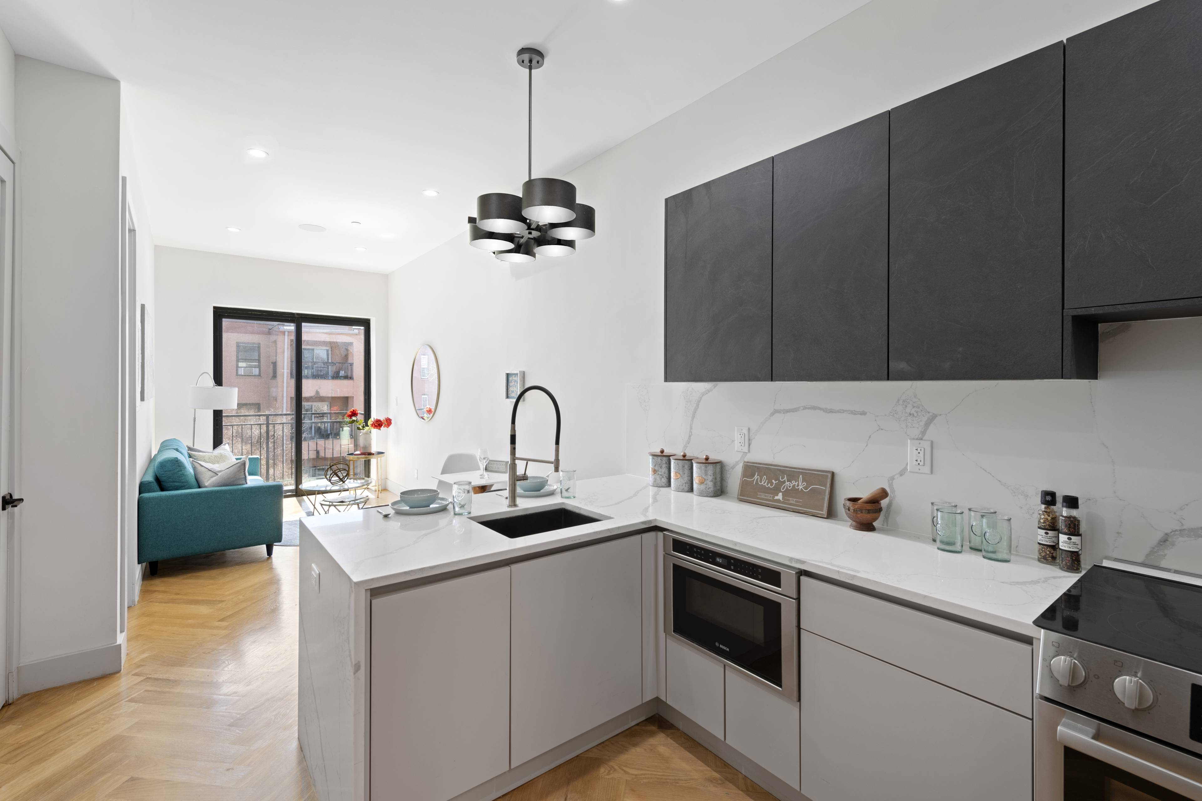 Effortless designer style combines with exceptional private outdoor space in this stunning one bedroom plus bonus room, two bathroom penthouse duplex in a boutique new construction Bed Stuy condominium.
