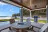 Covered patio pool deck with firepit and seating area