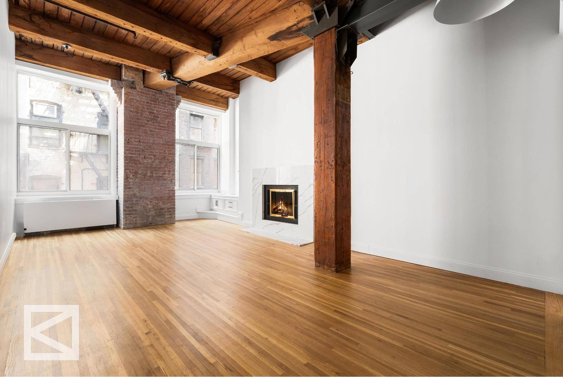 Beautifully renovated three bedroom, two bathroom corner loft, boasting soaring 12' beamed ceilings, exposed brick, two wood burning fireplaces and new oversized 8' thermal windows.
