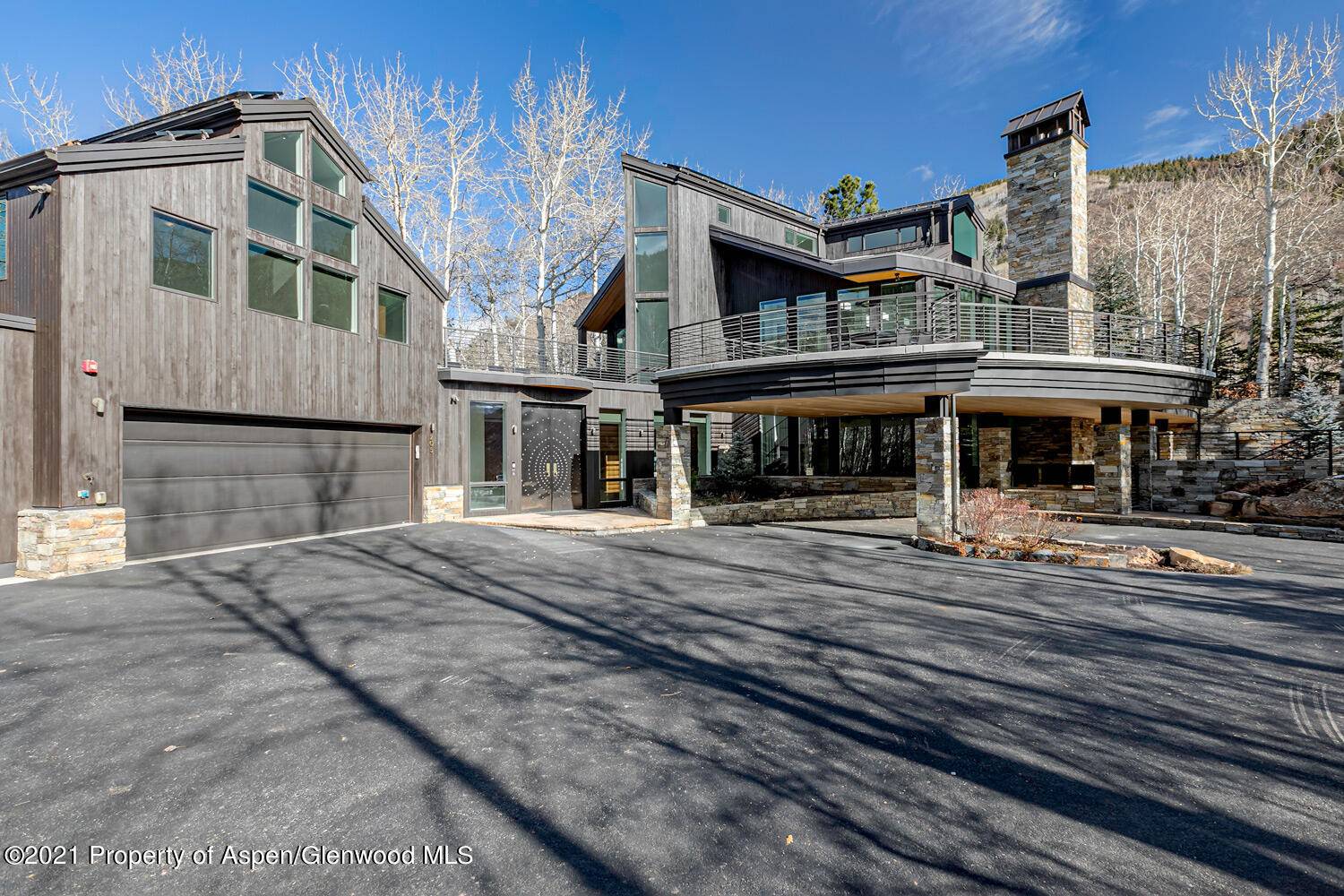 Located in East Aspen is a private enclave on Roaring Fork Drive is an exquisite, thoughtfully designed home located on a large lot with beautiful, manicured lawns and gardens and ...