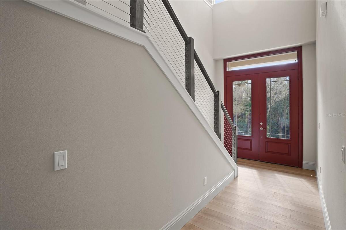 Grand foyer makes an immediate impression wit its soaring two-story ceilings and abundant natural light. Impressive double front doors with decoratio