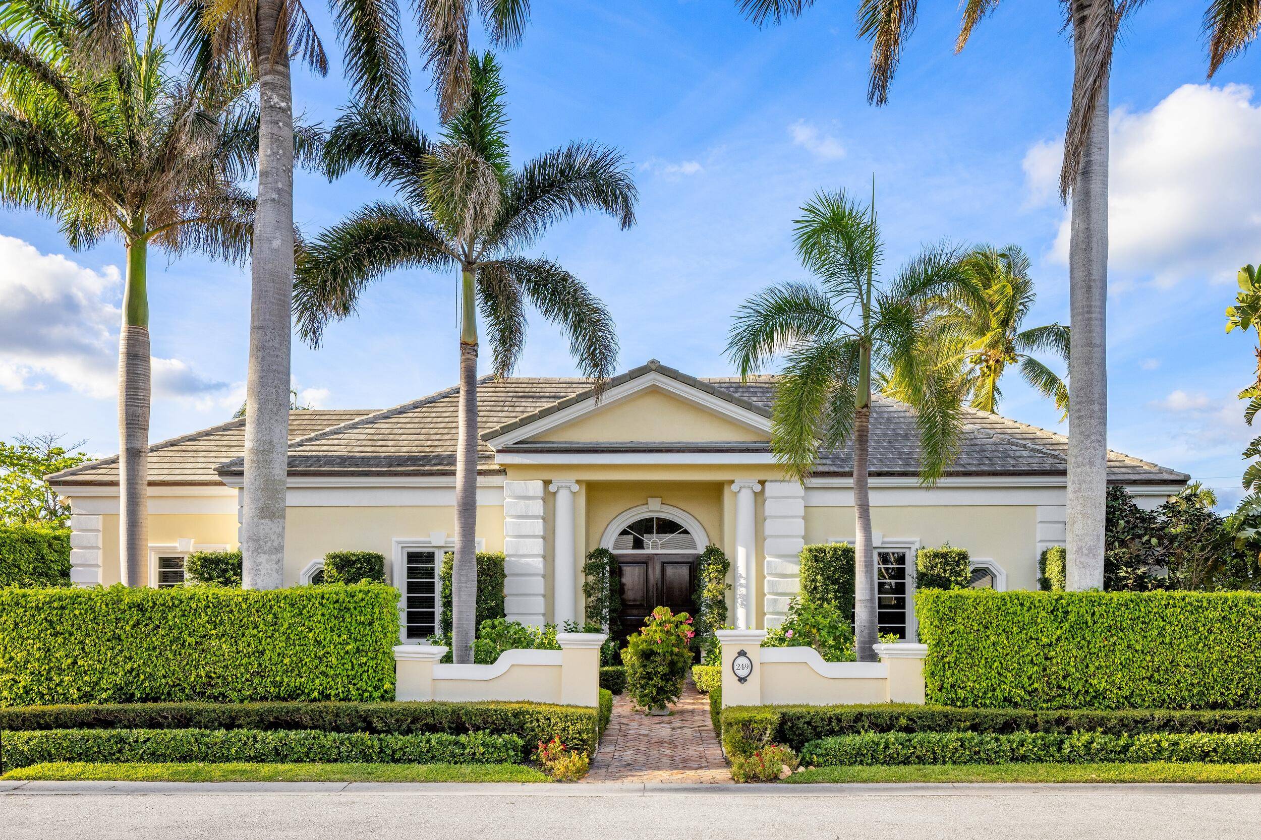 This one story North End Palm Beach home features five bedrooms, a chef's kitchen, formal dining room, and elegant living areas with high ceilings and hardwood floors throughout.