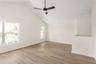 Level Three: Living room featuring Vaulted Ceiling