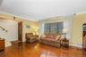 Hardwood flooring throughout, a decorative front entry door, and a large front-facing window