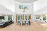 Dining space featuring a high ceiling, a chandelier, and light wood-type flooring