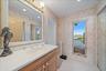 PRIMARY BATHROOM (his or her side with sink and mirrored built in closet system