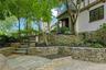 Extensive stacked stone masonry adorns the facade of this beautiful Tudor boasting a radiant heated driveway, steps and front path for winter safety a