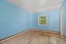 Unfurnished room featuring a baseboard heating unit and vaulted ceiling