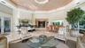 Soaring vaulted great room with a bar, dining, and lounge areas, seamlessly oriented to showcase the dramatic circular kitchen