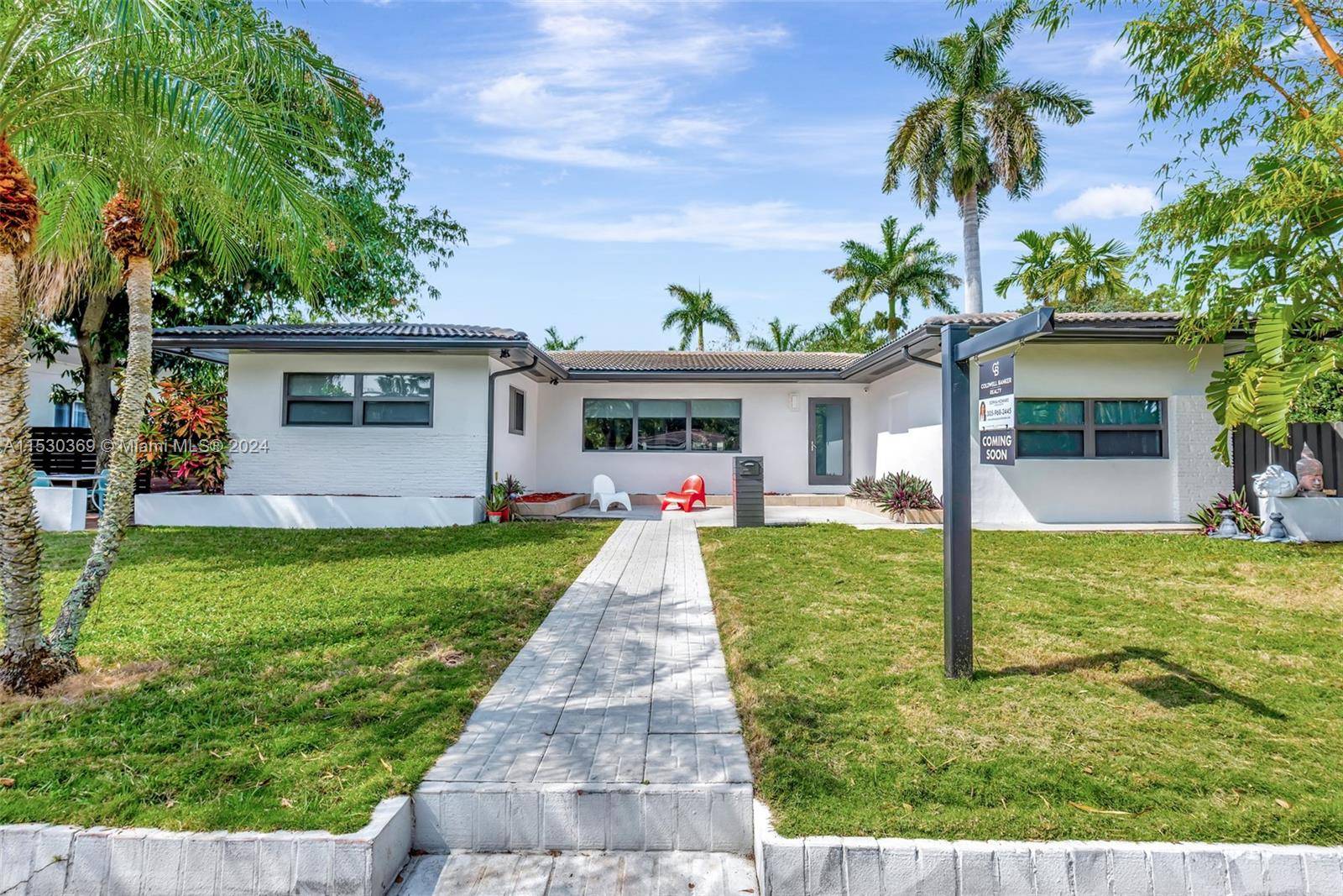 Welcome to this stunning mid century home, nestled in desirable Miami Shores golf club community, situated on a beautiful private street.