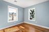 Spare room with baseboards and wood finished floors