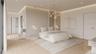 Custom vertical millwork and sculptural lighting define the suite’s refined, modern character. An open, flowing layout enhances both privacy and prese