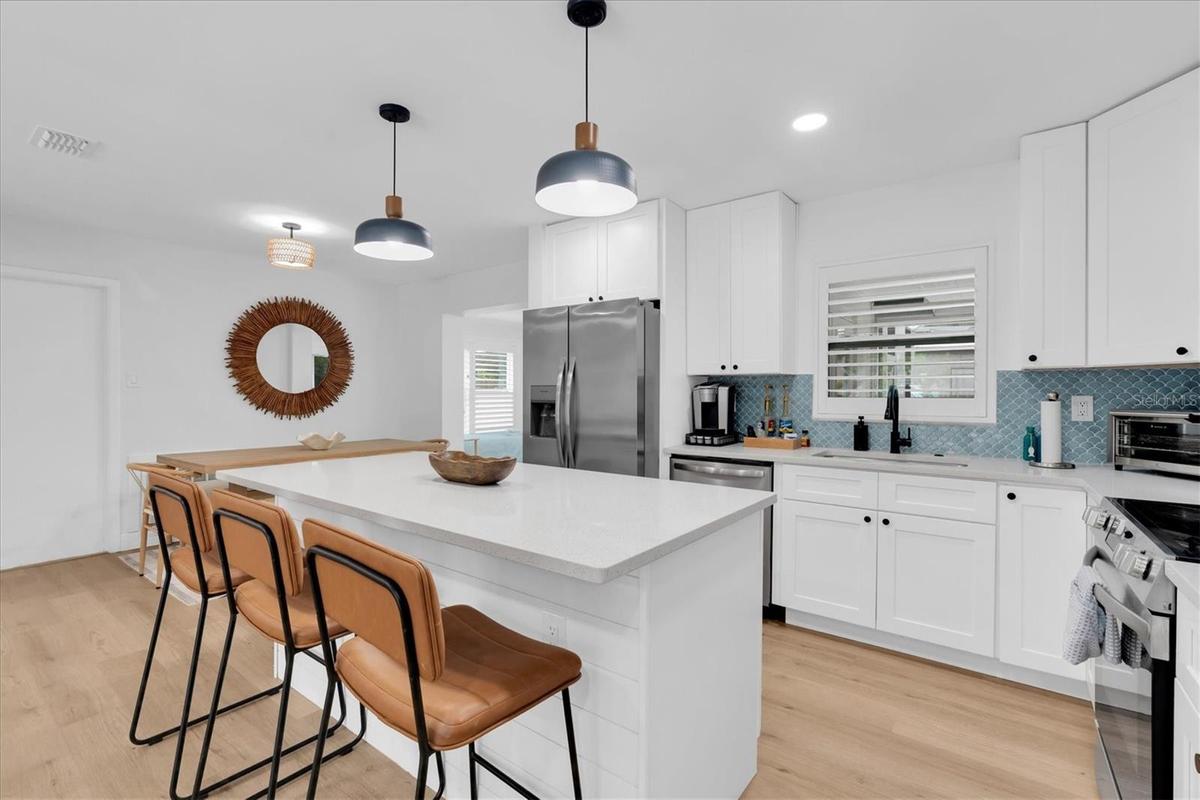 Kitchen with Quartz Countertops + Stainless Steel Appliances