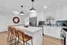 Kitchen with Quartz Countertops + Stainless Steel Appliances