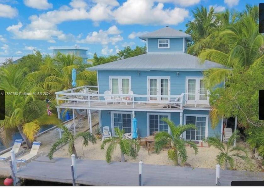 Explore this private Caribbean Keys Duplex Villa, the last home on a cul de sac.