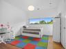 Bedroom with wood finished floors and baseboards