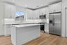#7 Dove white kitchen cabinets with island with overhang for additional seating