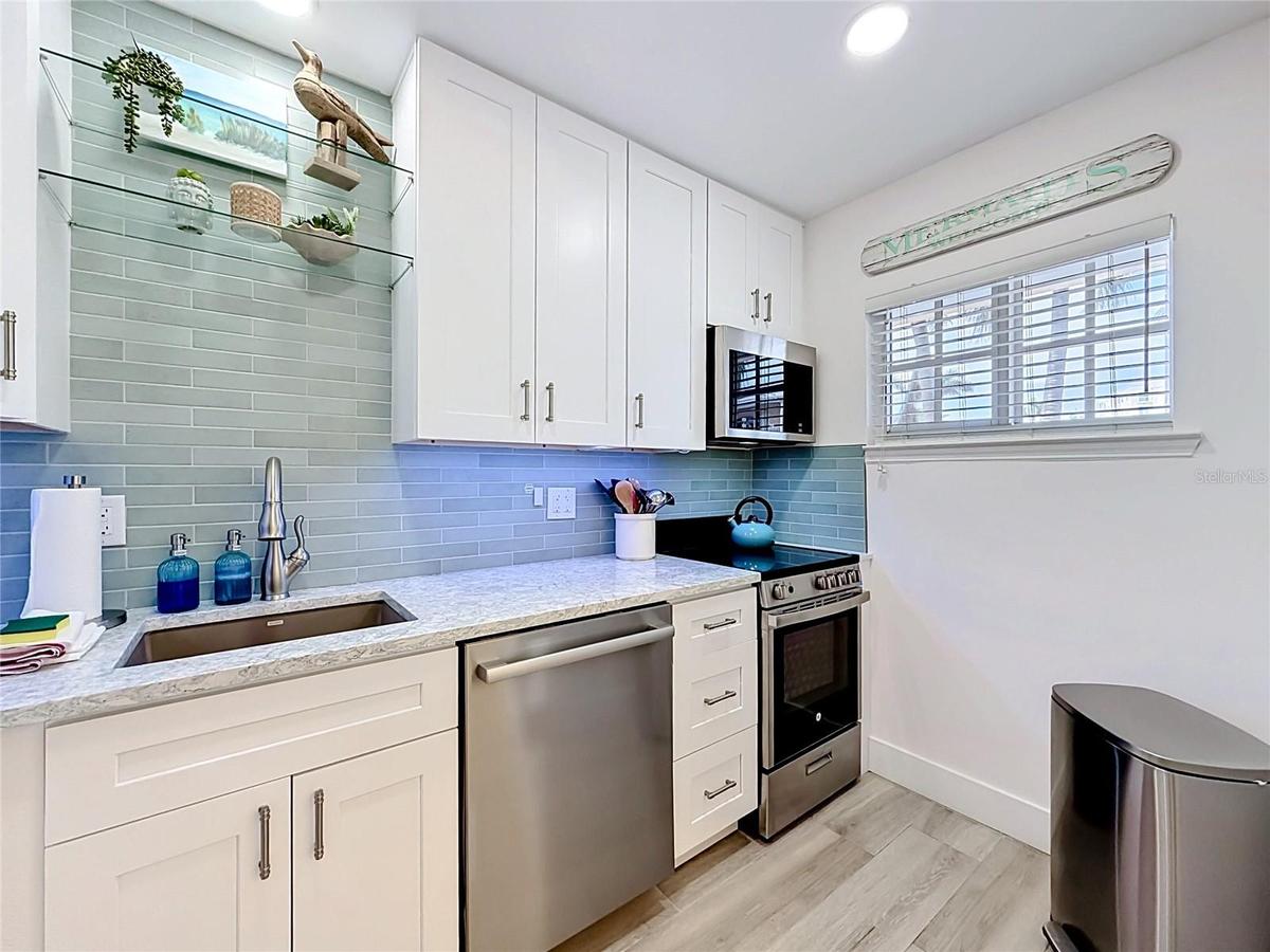 Closer look at the kitchen that offers ample counter space with the custom sized appliances that were newly installed.