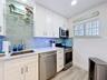 Closer look at the kitchen that offers ample counter space with the custom sized appliances that were newly installed.