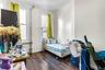 Room featuring wood-finish flooring and white painted walls