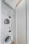 Laundry area with stacked washing machine and dryer