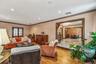 Living area featuring crown molding, hardwood / wood-style flooring, recessed lighting, stairs, and a chandelier