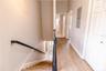 Beautiful hallway with clean lines creates a seamless flow to full bathroom and bedroom.