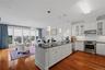 Spacious granite breakfast bar overlooks the living room and large sun-filled windows.