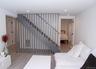 Stairs featuring wood finished floors and recessed lighting