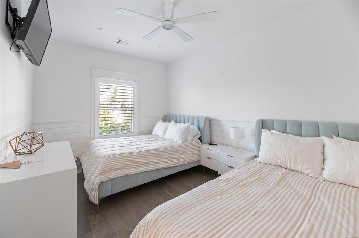 Bedroom featuring dark wood-type flooring and ceiling fan