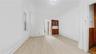 Spare room featuring light wood-type flooring and baseboards