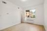 Empty room with radiator heating unit and light wood-style floors