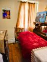 Bedroom featuring baseboards and dark wood-type flooring