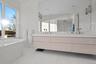 Bathroom featuring plus walk in shower and vanity
