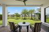 covered patio overlooking the backyard. Newly planted palm trees and a mango tree for extra shade in the backyard