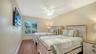 Guest bedroom with wood flooring