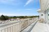 Balcony with a water view and a view of the beach