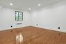 Nestled on the third level, this spacious bedroom offers privacy, abundant natural light, and an oversized walk-in closet space, making it an ideal re