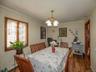 Dining area featuring a chandelier, baseboard heating, dark wood finished floors, and crown molding