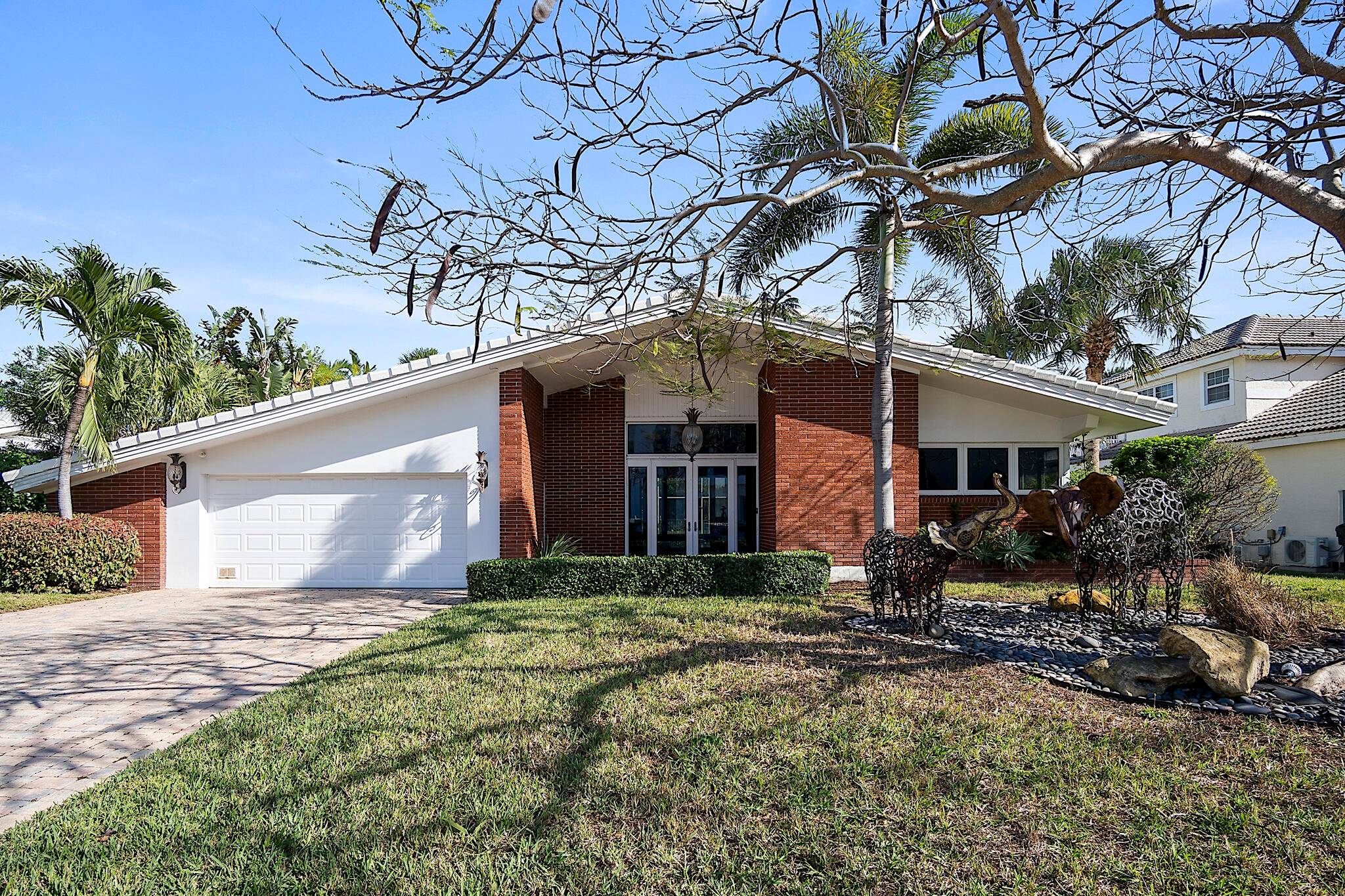 Located in the prestigious Sun Surf Club Community off A1A and One of only 16 Homes located on Red Reef Park Golf Course this Home or Lot has endless possibilities.