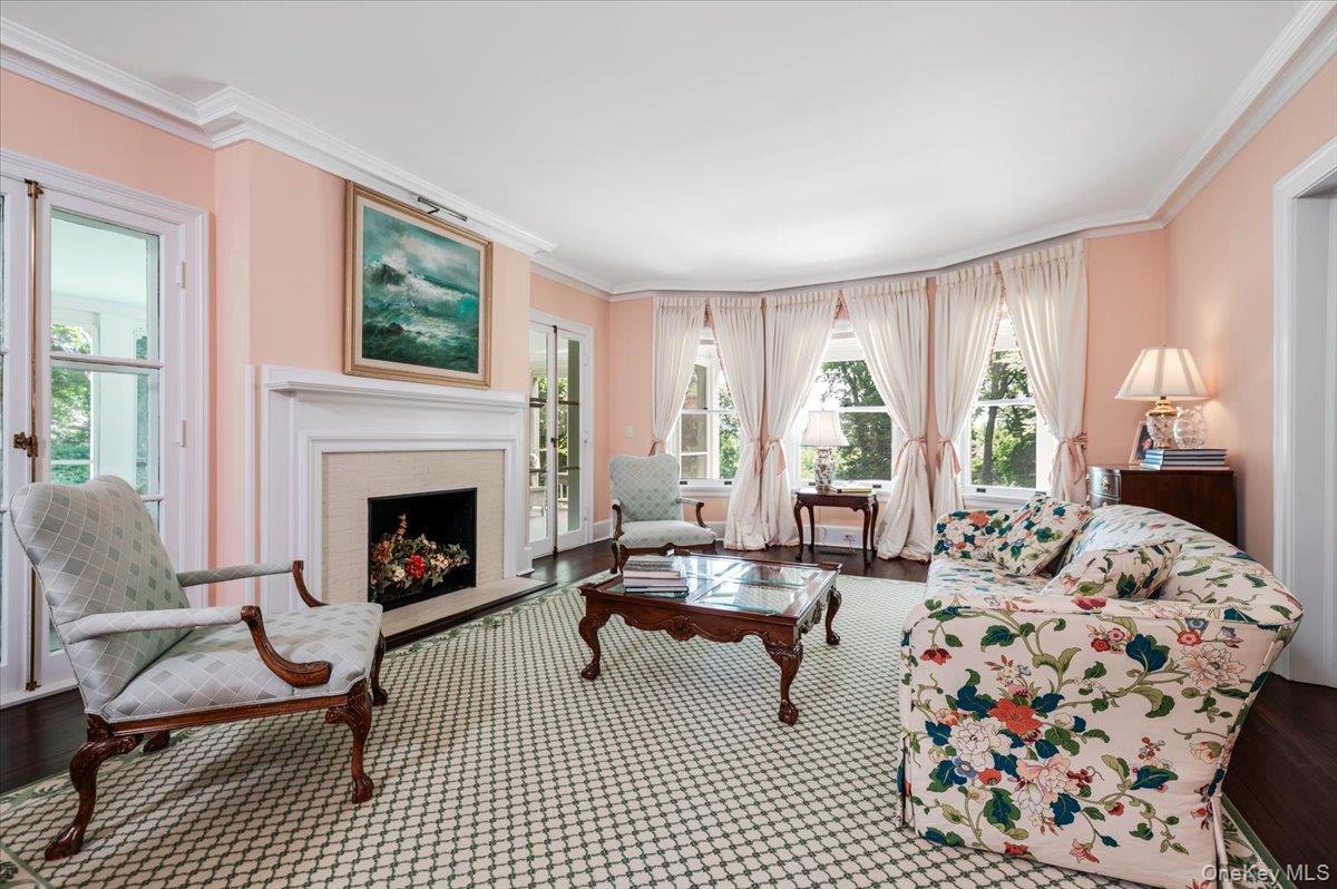 3 Sets of French doors, hardwood floors, wood burning fireplace and generous sized windows throughout