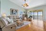 Spacious living room connected to enclosed lanai with all-weather protection and fabulous waterfront views