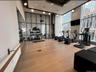 Workout area with floor to ceiling windows and a high ceiling