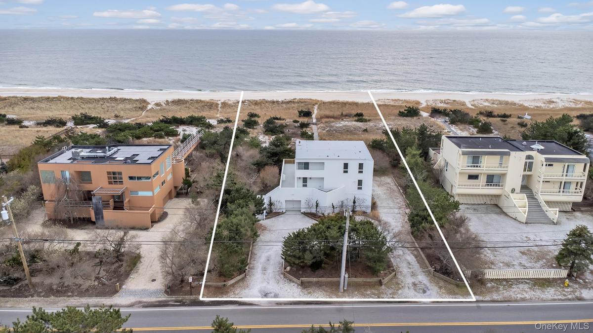Drone / aerial view with a water view and a view of the beach