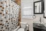 Full bathroom featuring vanity and shower / bath combination with curtain