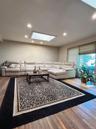 Living area with a skylight, wood-type flooring, and recessed lighting